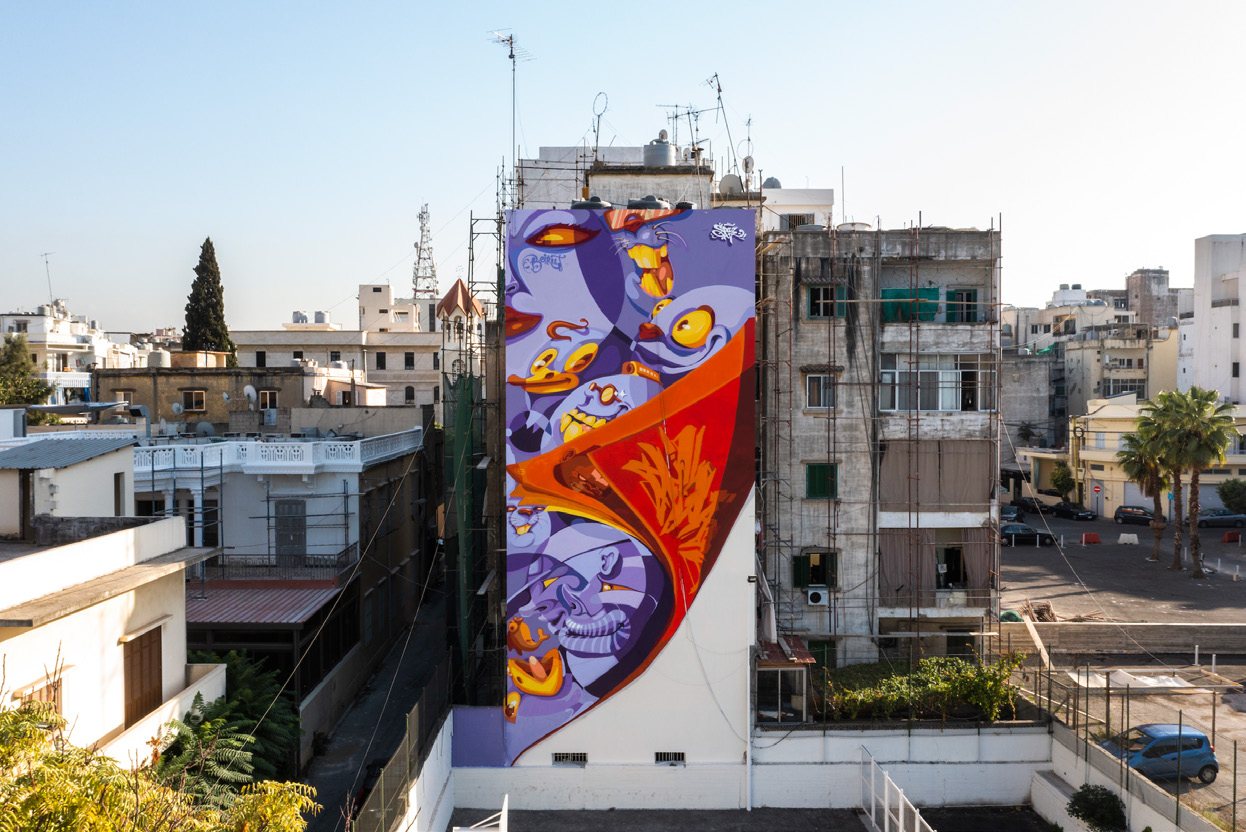 Flip the Page mural rising above the surrounding buildings in Beirut, 2022.